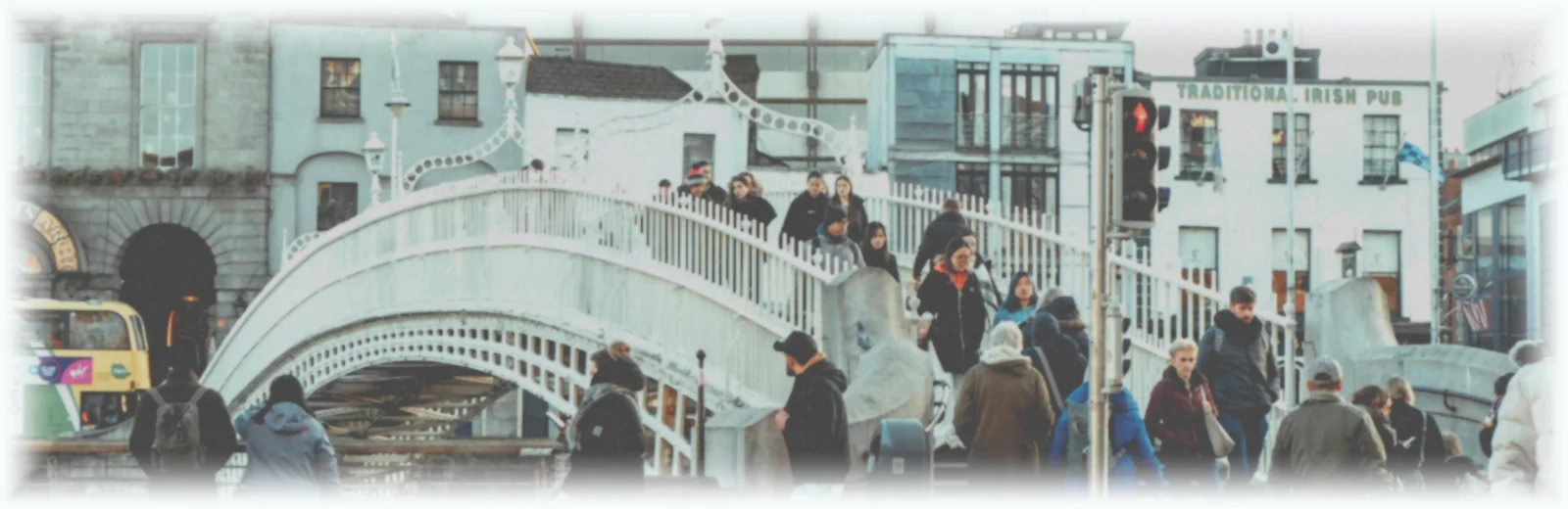 People crossing the Ha'penny Bridge in Dublin